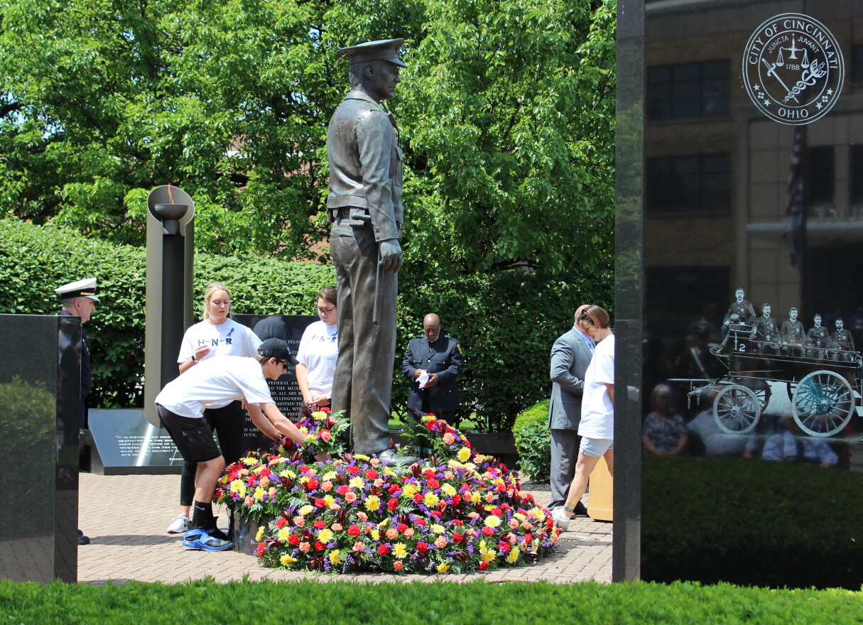 The children of Dale Woods lay flowers around the memorial.